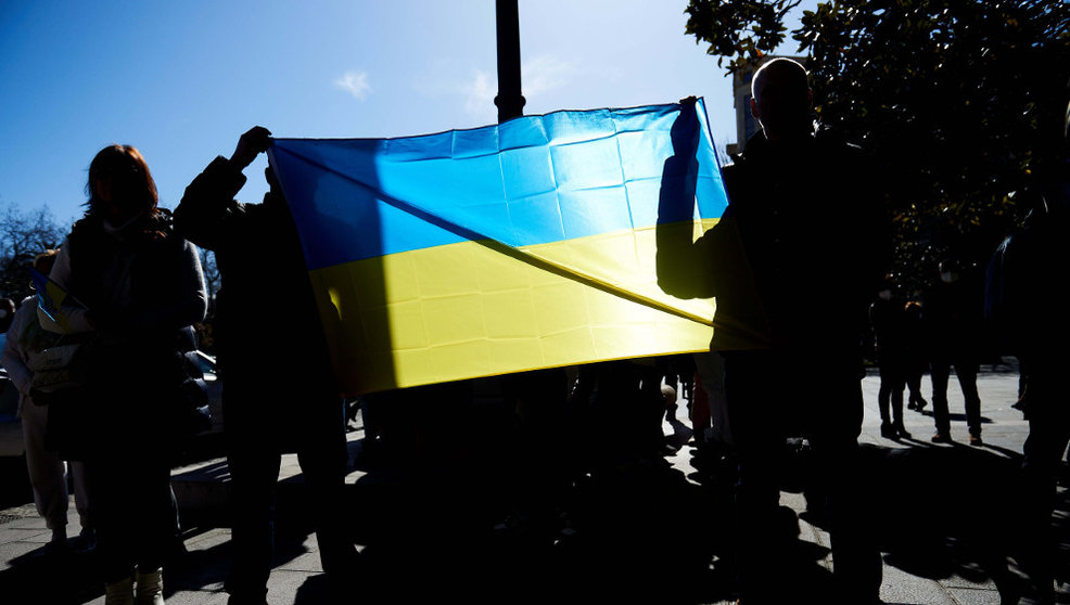 Varias personas con una bandera de Ucrania se manifiestan contra la guerra en Santander