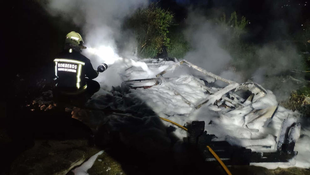 Los bomberos del 112 extinguen el fuego que ha calcinado una caravana en Pando